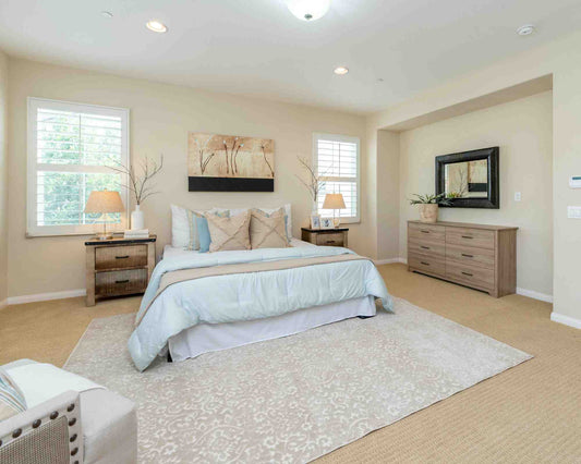 Modern design master bedroom featuring a king-size bed, bedside tables, and a contemporary cupboard.