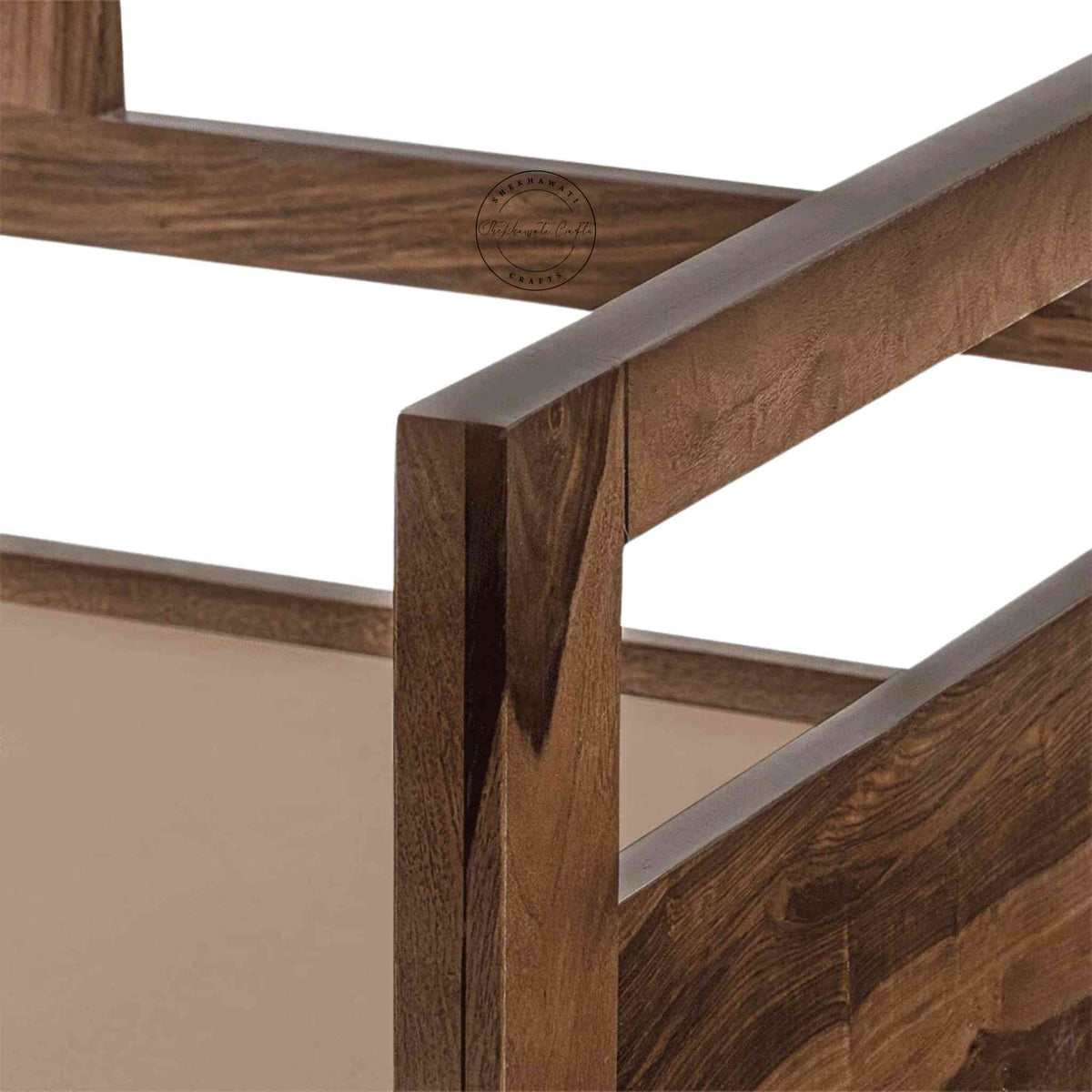 Close-up view of a foldable wooden daybed made of Sheesham wood with natural finish sits in a white background.