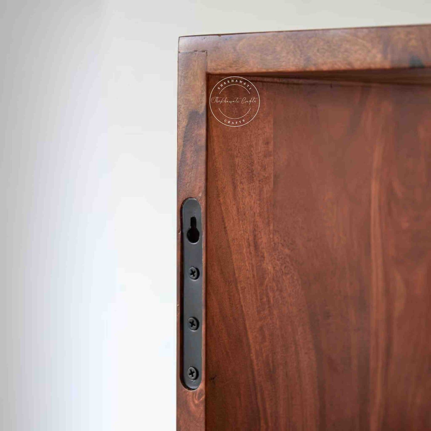 bluewud wall rack is handcrafted with sheesham wood. Featuring a honey finish, 2 drawers and a design that is easy to hang on the wall.