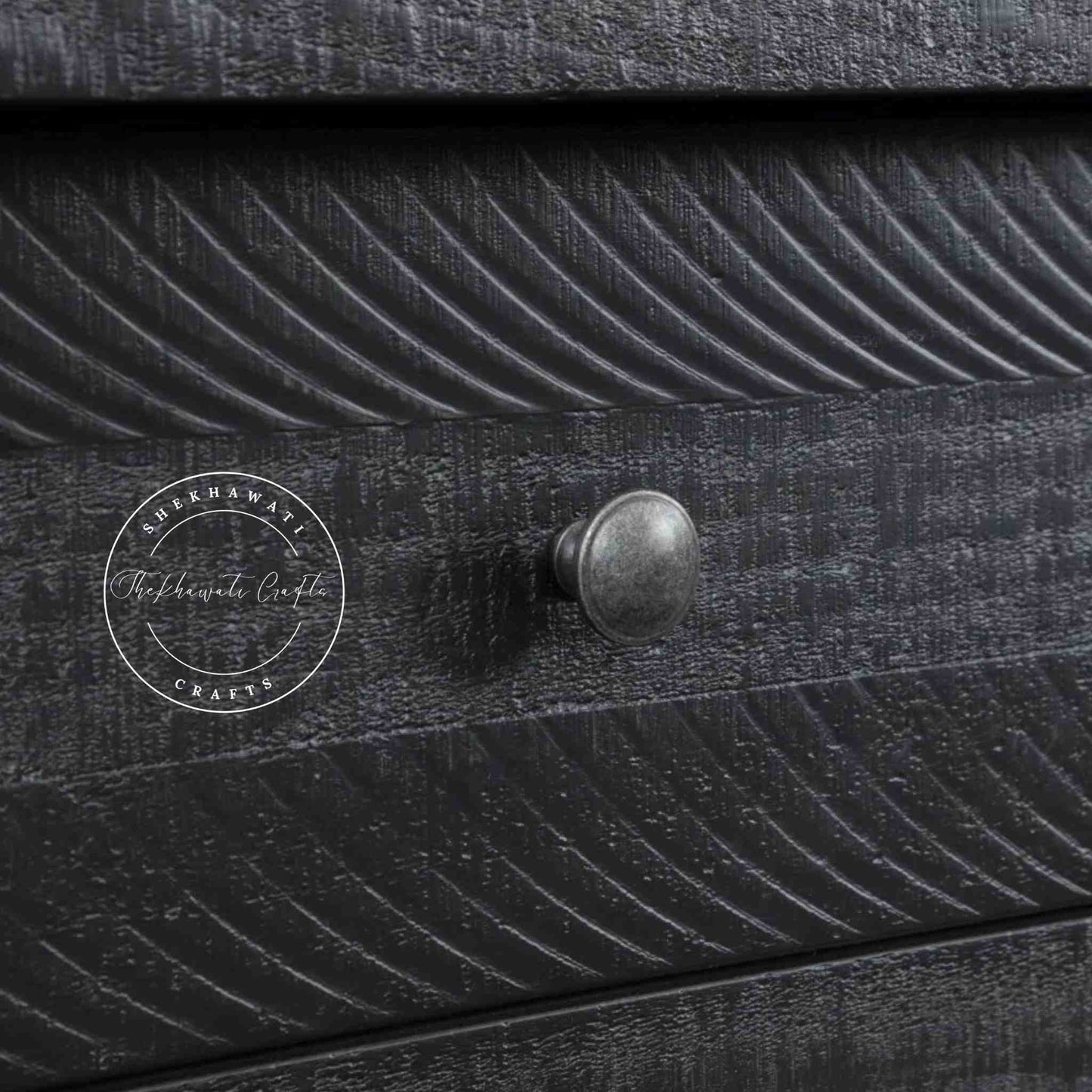 Julian console table is handcrafted from mango wood and a matte black finish.