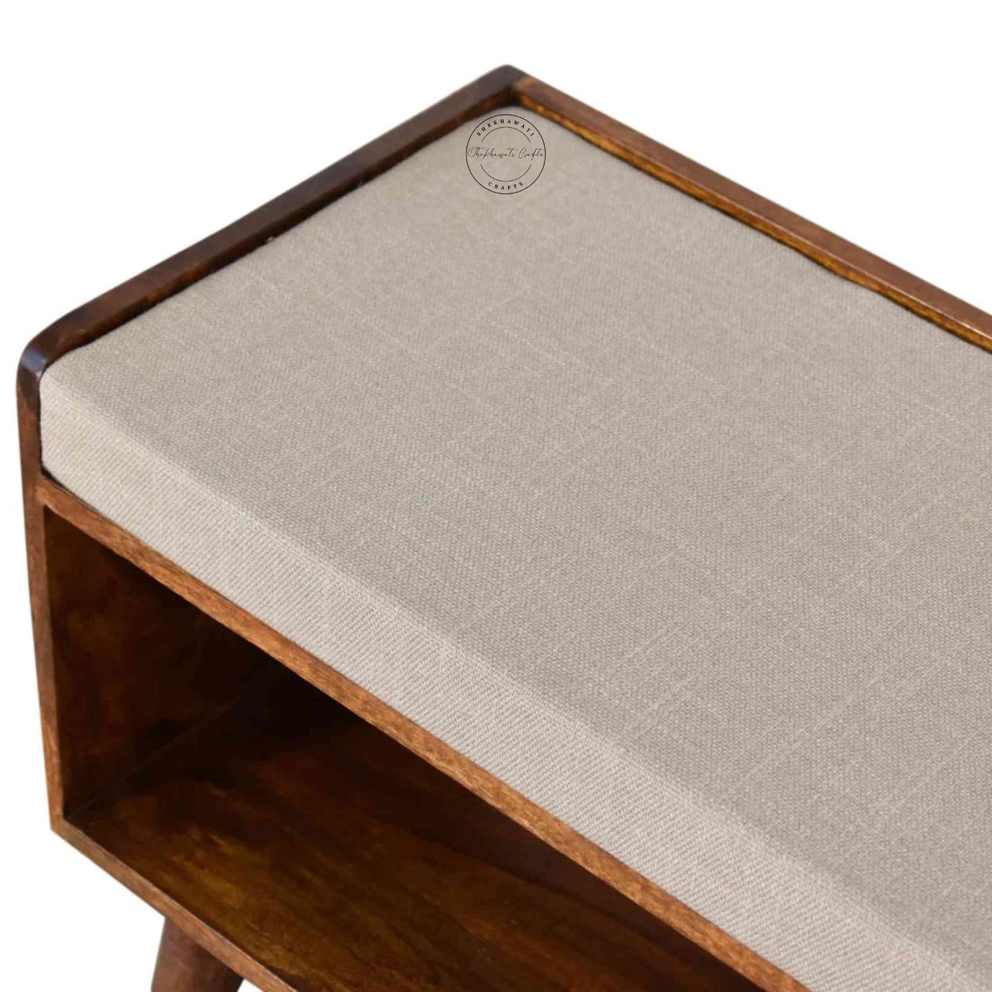 Lammi Bench is handcrafted with sheesham wood, cushion, honey finish, detachable legs and a storage shelf.