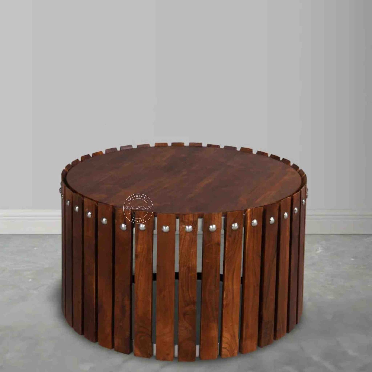 Handcrafted from Sheesham wood, the Leore Coffee Table features a round shape design and warm honey finish.