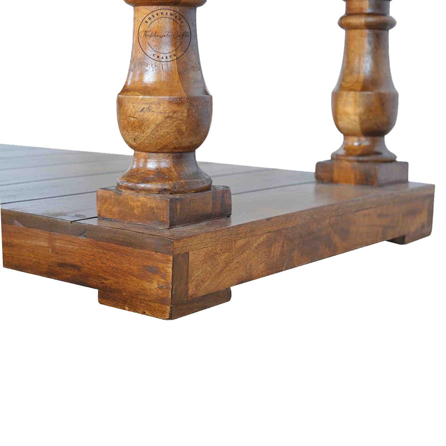 New City Center Table is made from Sheesham wood with a honey finish, antique-inspired design and bottom shelf storage.