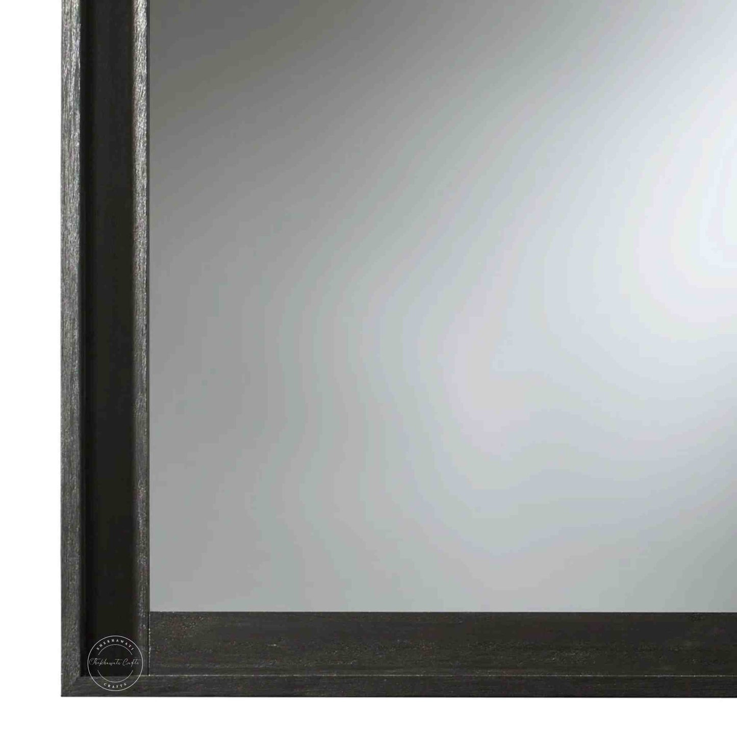 Noir mirror frame is crafted from mango wood with a matte black finish.