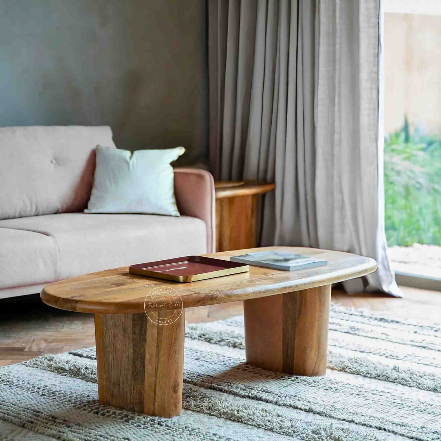 Handcrafted Tiara Mango Wood Coffee Table featuring an oval design and foldable legs.