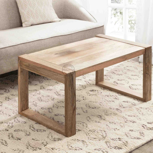 Travis Center Table is handcrafted from mango wood and features a natural finish with foldable legs.
