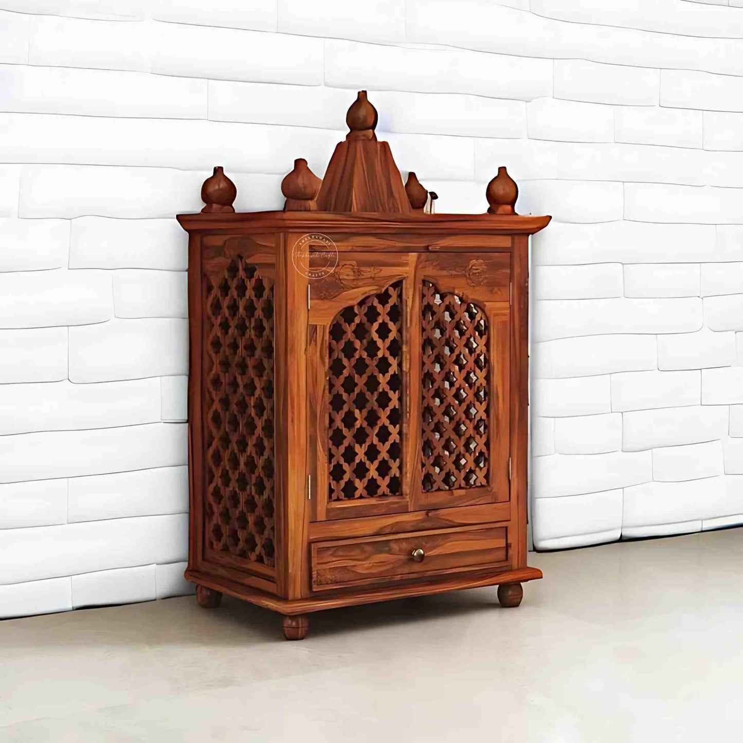 Trayee wooden temple is handcrafted from sheesham wood and features a unique Shekhawati wooden jali design, complete with 2 doors and 1 drawer.