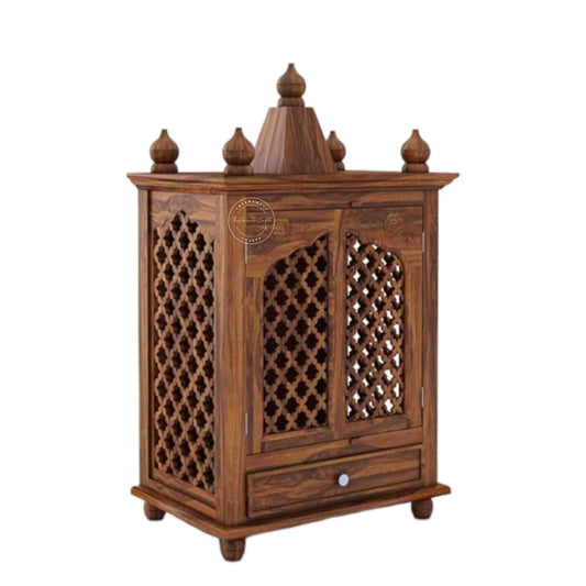 Trayee wooden temple is handcrafted from sheesham wood and features a unique Shekhawati wooden jali design, complete with 2 doors and 1 drawer.
