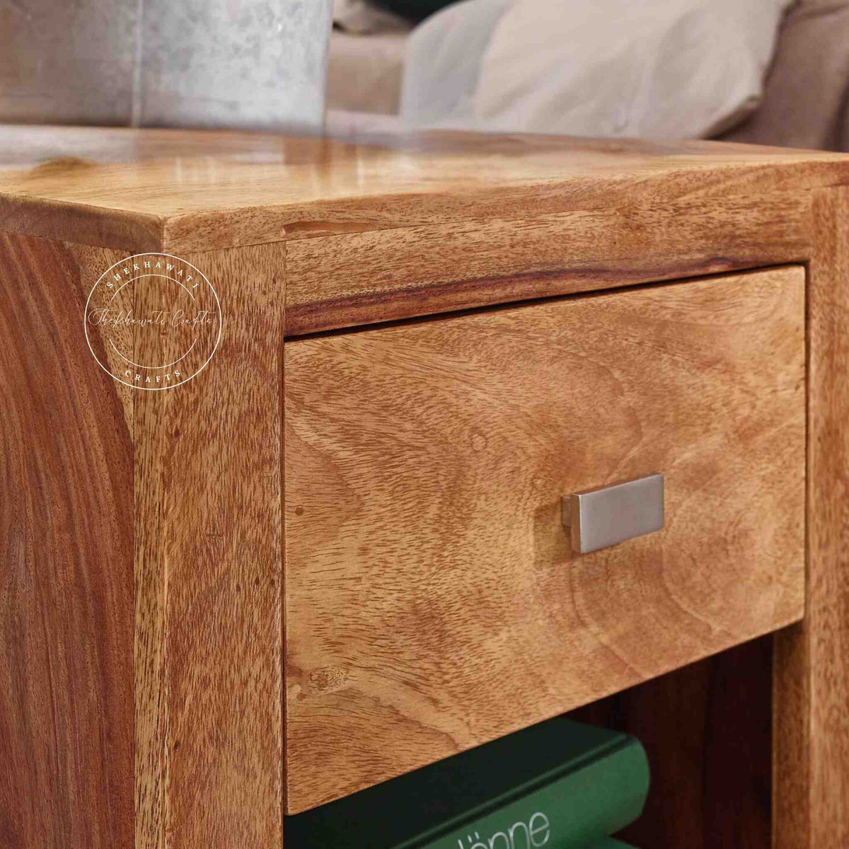 Close-up view of a Handcrafted Zoey Bedside table made from sheesham wood with 1 drawer and 1 open shelf, featuring a natural finish.