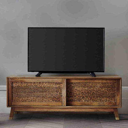 The Aarika handcrafted wooden TV cabinet is made from mango wood and features sliding doors.