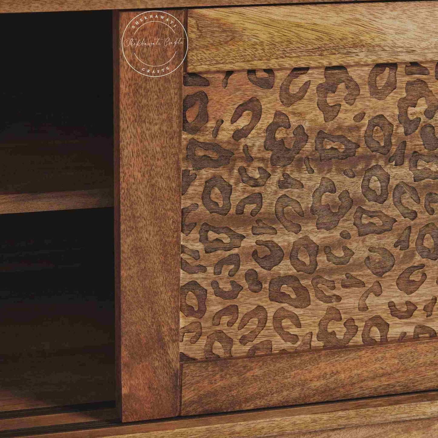 The Aarika handcrafted wooden TV cabinet is made from mango wood and features sliding doors.