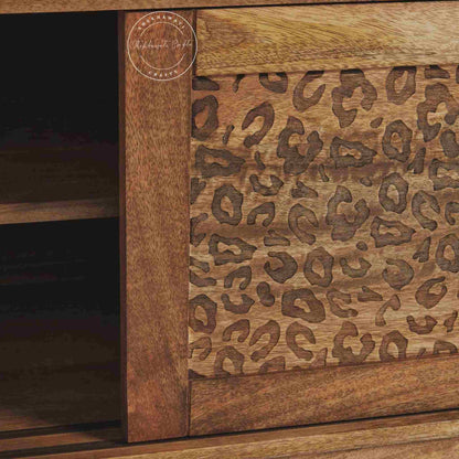 The Aarika handcrafted wooden TV cabinet is made from mango wood and features sliding doors.