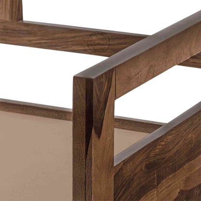 Close-up view of a foldable wooden daybed made of Sheesham wood with natural finish sits in a white background.