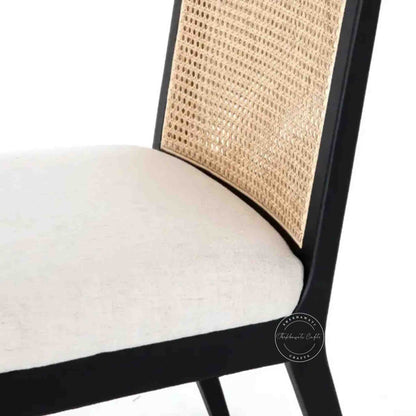 handcrafted Anvi Chair is made with sheesham wood and ratan cane design backrest.