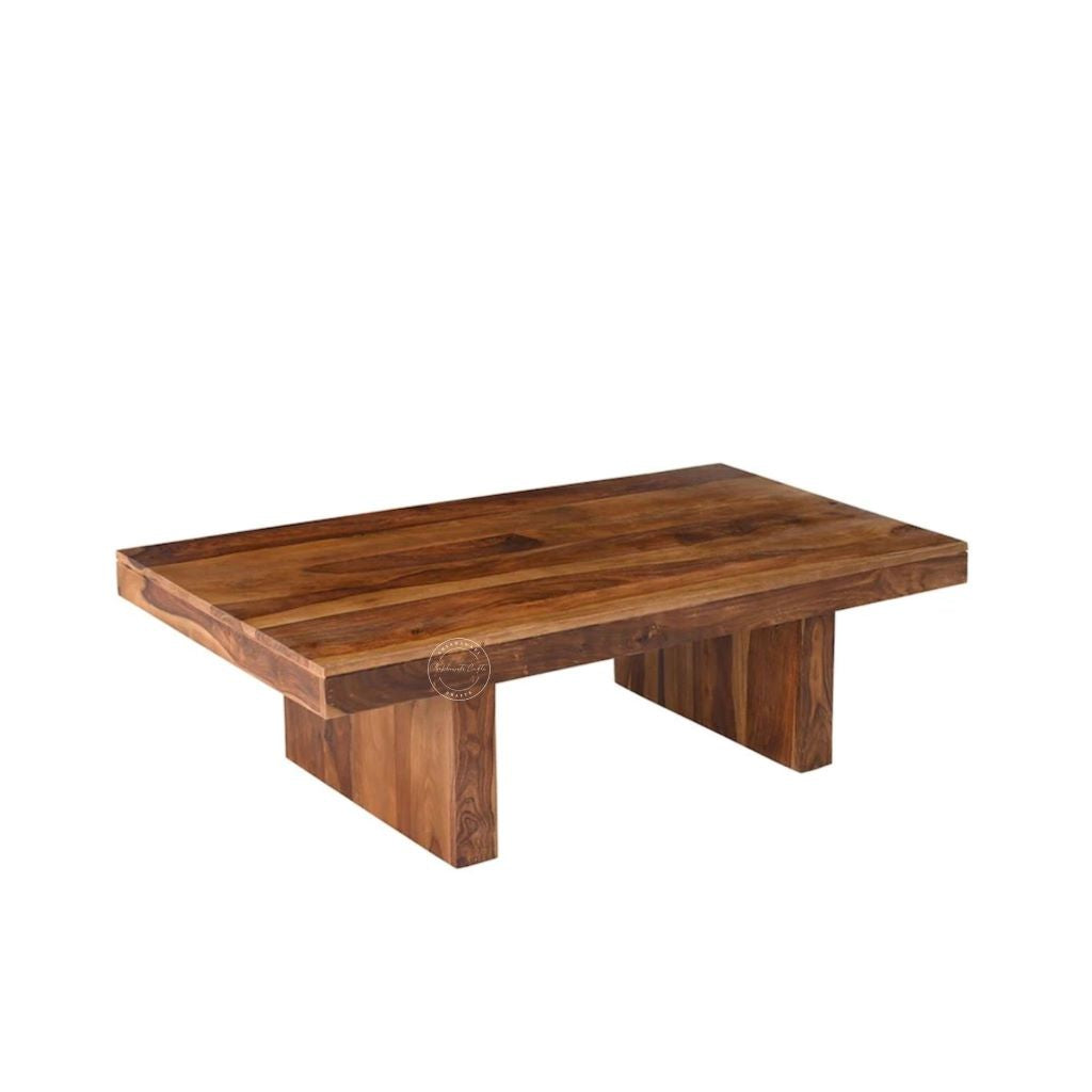 A rectangular sheesham wood centre table with a rich medium-brown finish and visible natural wood grain, shown from a three-quarters angle on a plain white background.