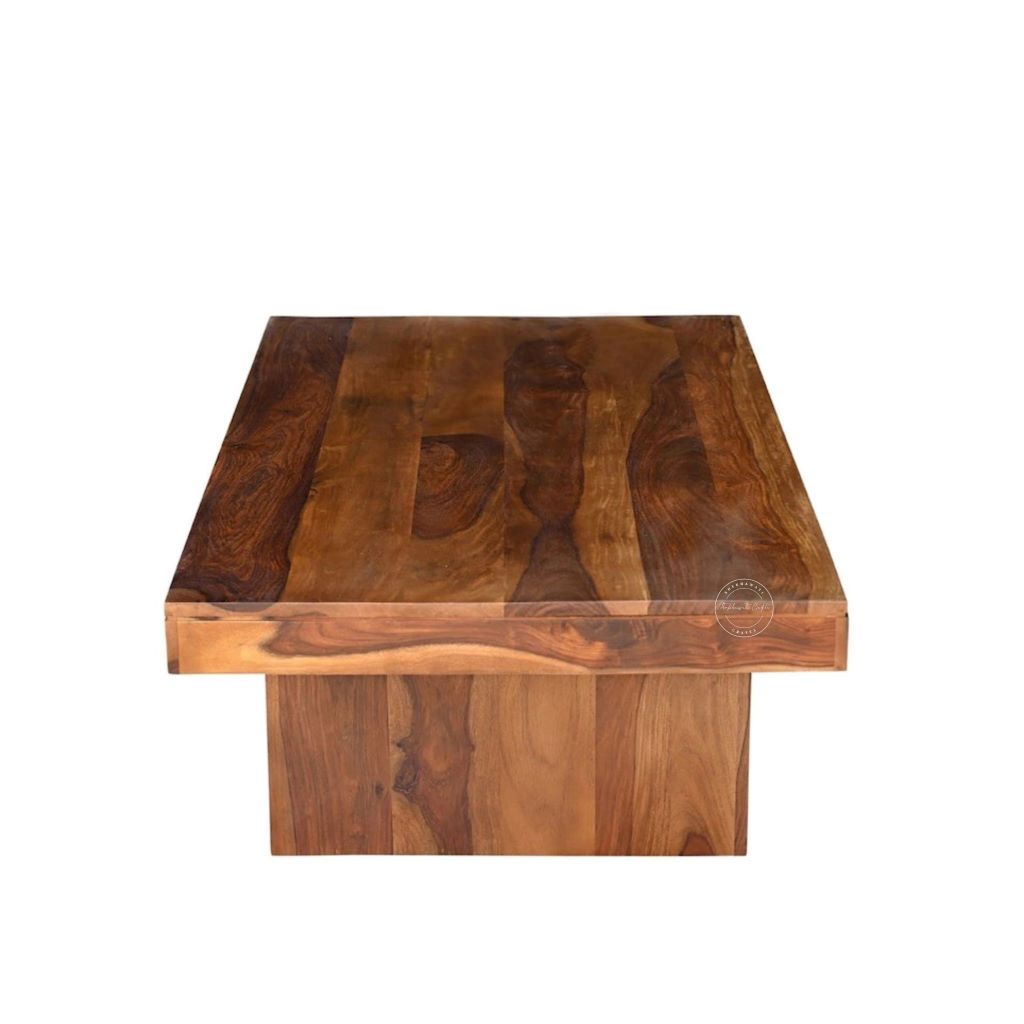 A rectangular sheesham wood centre table with a thick, raised apron base and a rich, warm brown wood grain finish, shown against a plain white background.