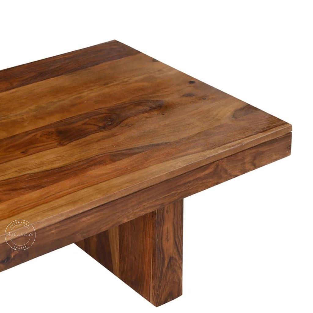 Close-up view of rectangular sheesham wood centre table with a rustic design on a white background.