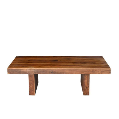 A rectangular sheesham wood centre table with a thick live-edge top and two block-style legs, shown against a plain white background.