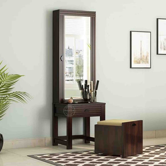 The Bergen dressing table is handcrafted from sheesham wood, featuring a mirrored storage door, one drawer, and a stool with storage options.