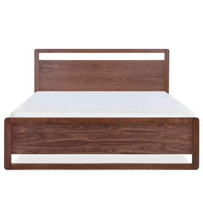 A king-size bed made of Sheesham wood with a headboard and footboard in white background.