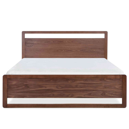 A king-size bed made of Sheesham wood with a headboard and footboard in white background.