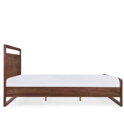 side view of a king-size bed made of Sheesham wood with a headboard and footboard in white background.