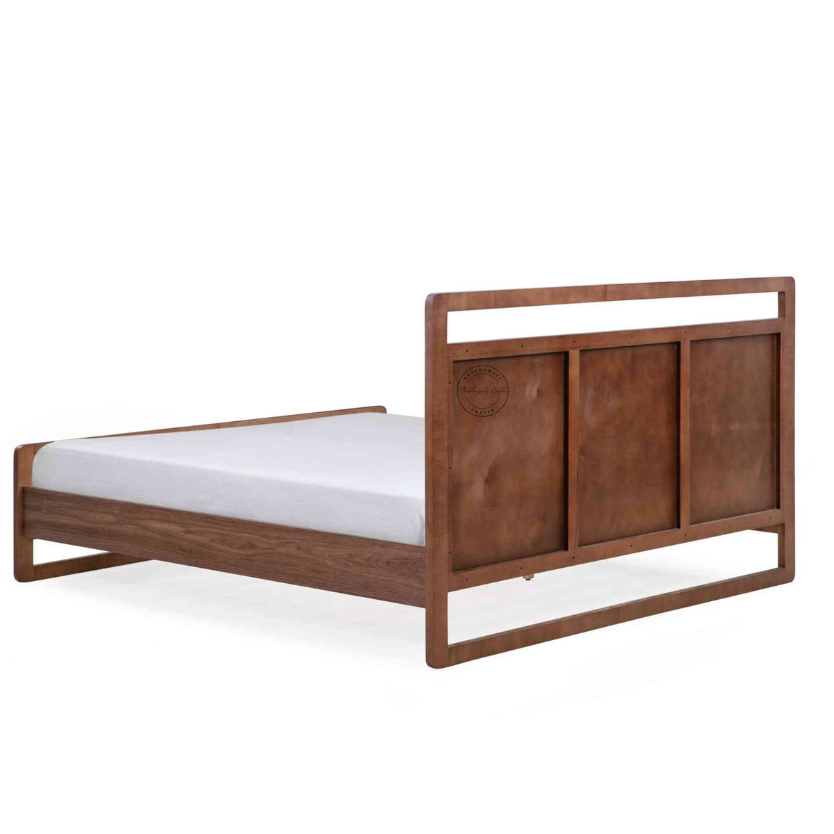 Back side view of a king-size bed made of Sheesham wood with a headboard and footboard in white background.