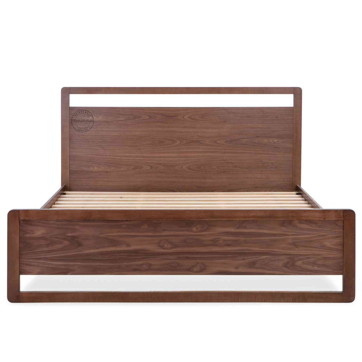 a king-size bed made of Sheesham wood with a headboard and footboard in white background.