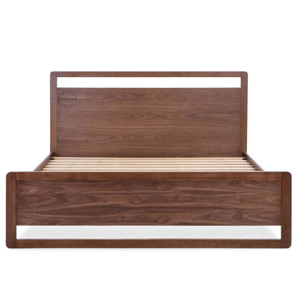 a king-size bed made of Sheesham wood with a headboard and footboard in white background.