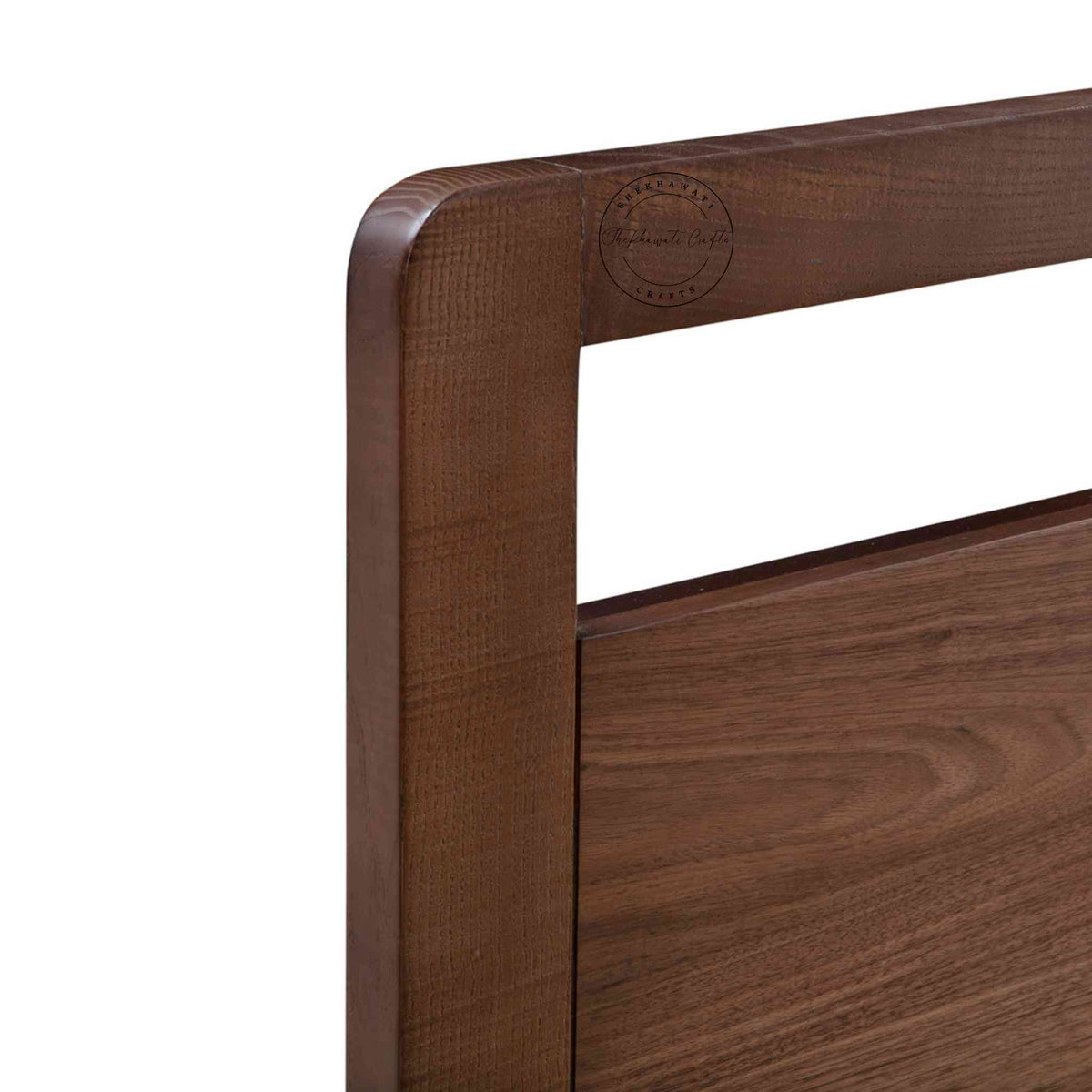 Close up view of a king-size bed made of Sheesham wood with a headboard in white background.