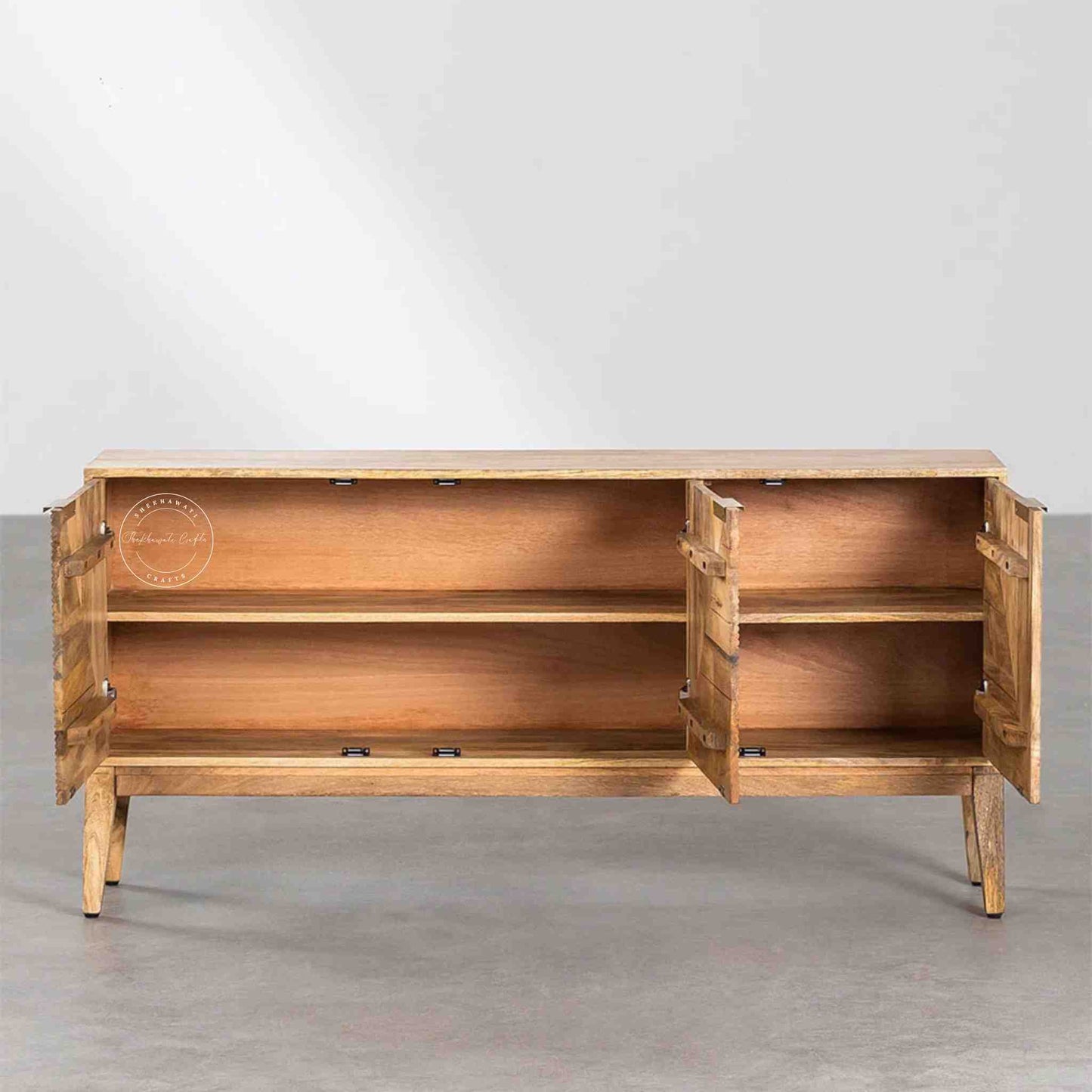 Brayan sideboard is handcrafted with mango wood. It has 3 doors and internal shelves for storage.