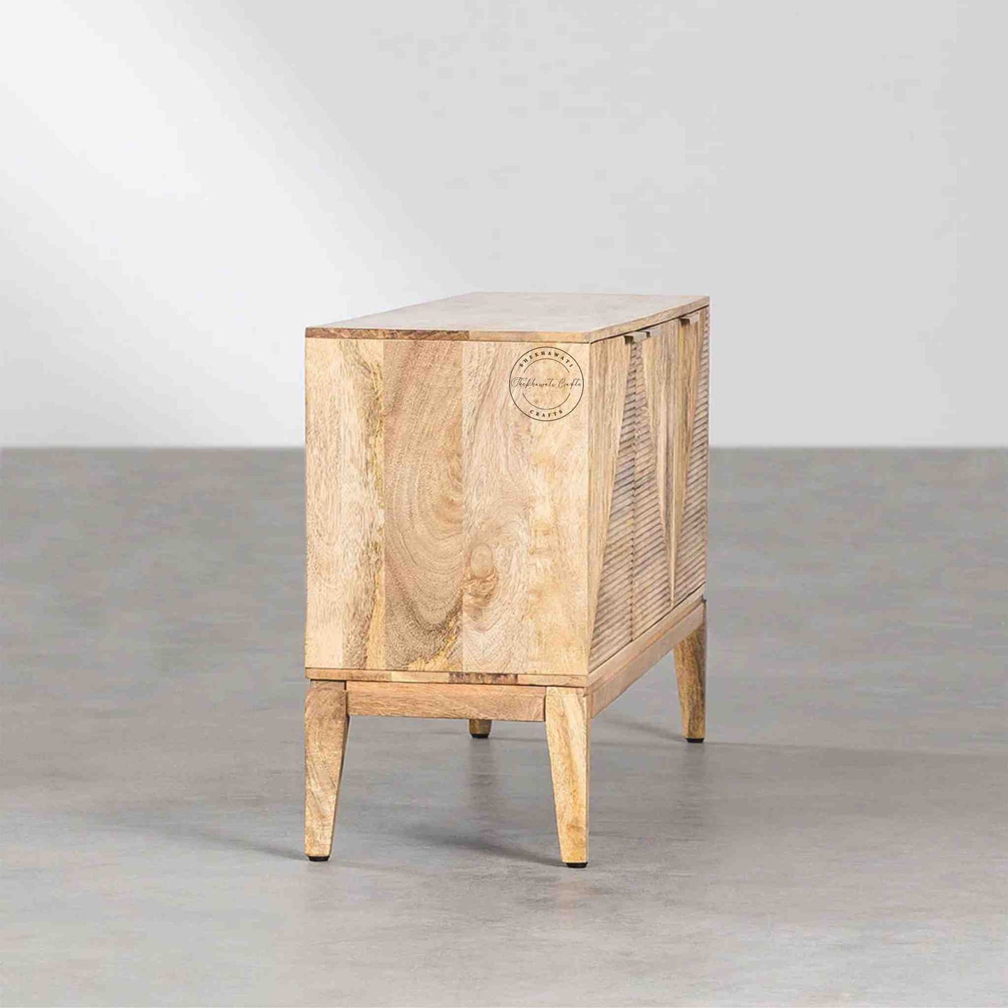 Brayan sideboard is handcrafted with mango wood. It has 3 doors and internal shelves for storage.
