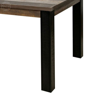 Close-up of a rustic wooden table showing a medium brown tabletop and dark black legs on a solid white background.