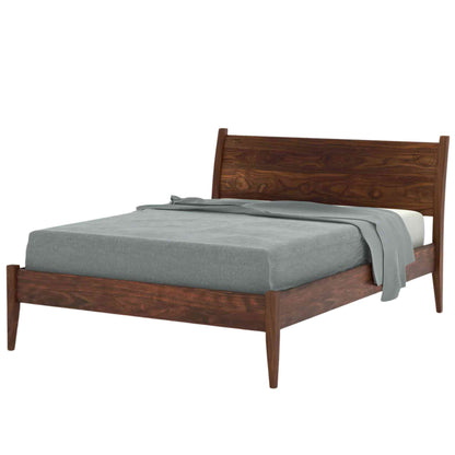 Side view of a king size bed made of Sheesham wood with a curved headboard shown in a white background.