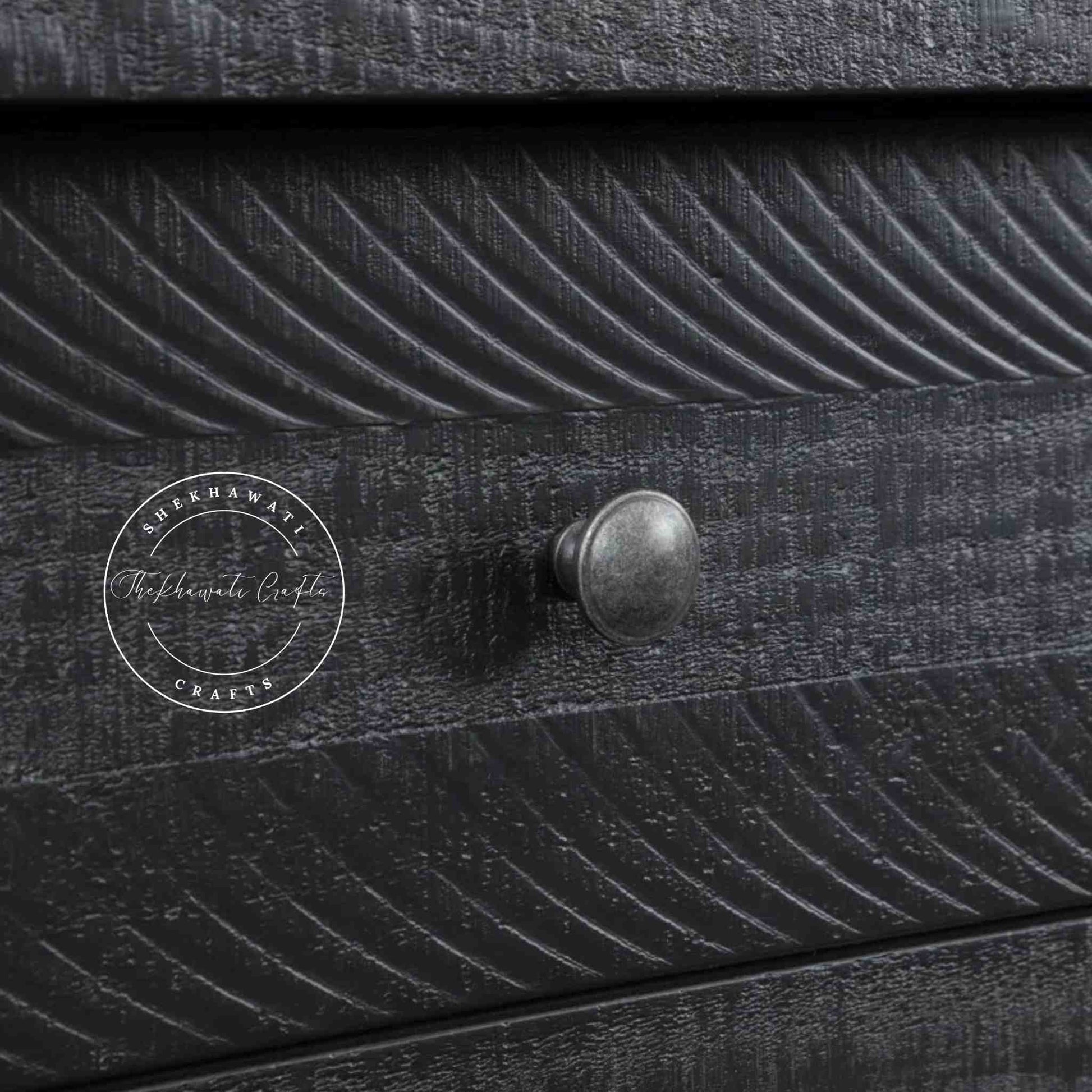 Julian console table is handcrafted from mango wood and a matte black finish.