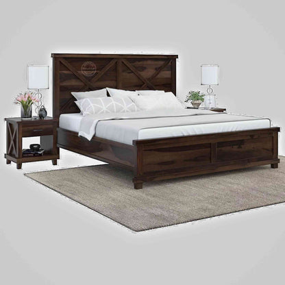 A king size wooden bed with a dark walnut finish, featuring a headboard and footboard, with bedding and pillows on it.
