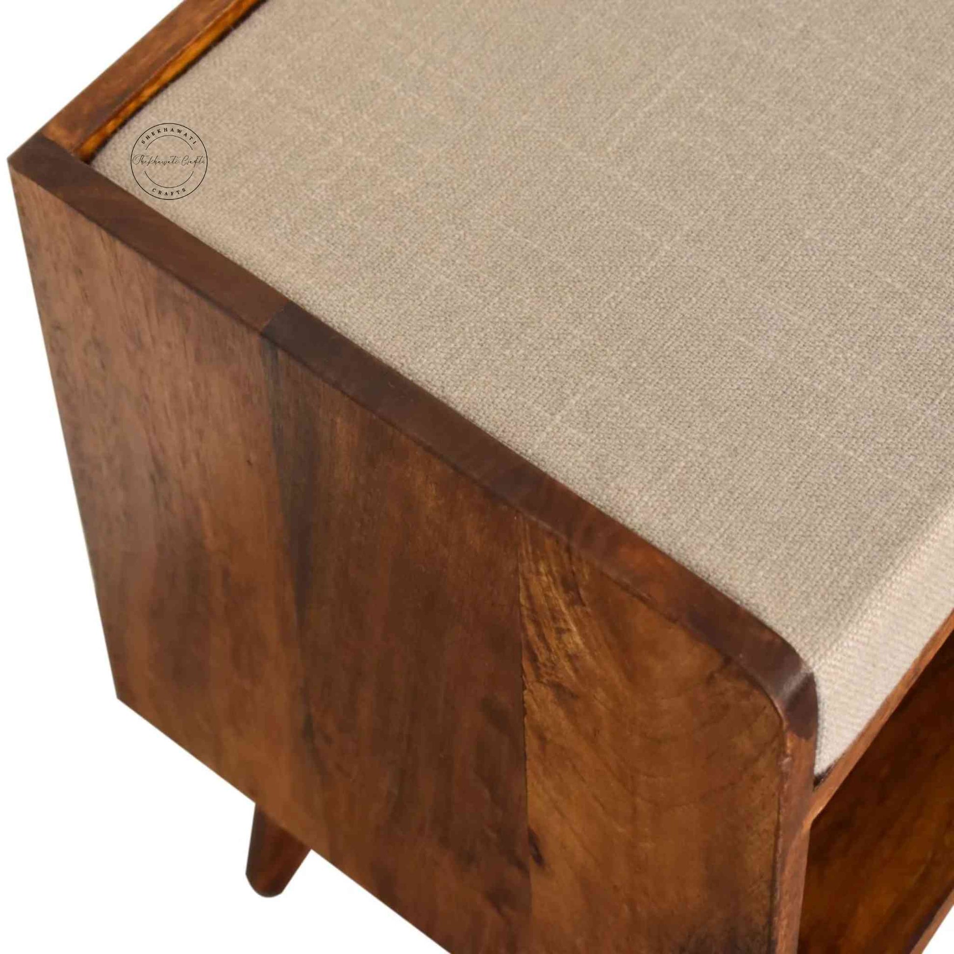 Lammi Bench is handcrafted with sheesham wood, cushion, honey finish, detachable legs and a storage shelf.