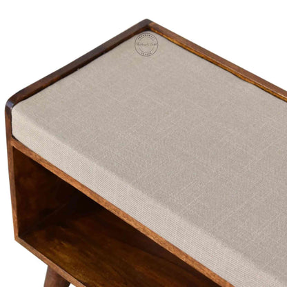 Lammi Bench is handcrafted with sheesham wood, cushion, honey finish, detachable legs and a storage shelf.