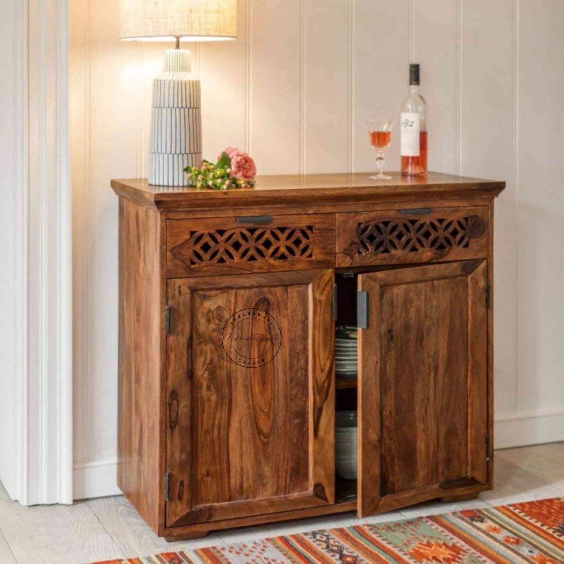 Handmade vintage Mirra 2-drawer sideboard made of sheesham wood with a honey finish and detachable shelves.