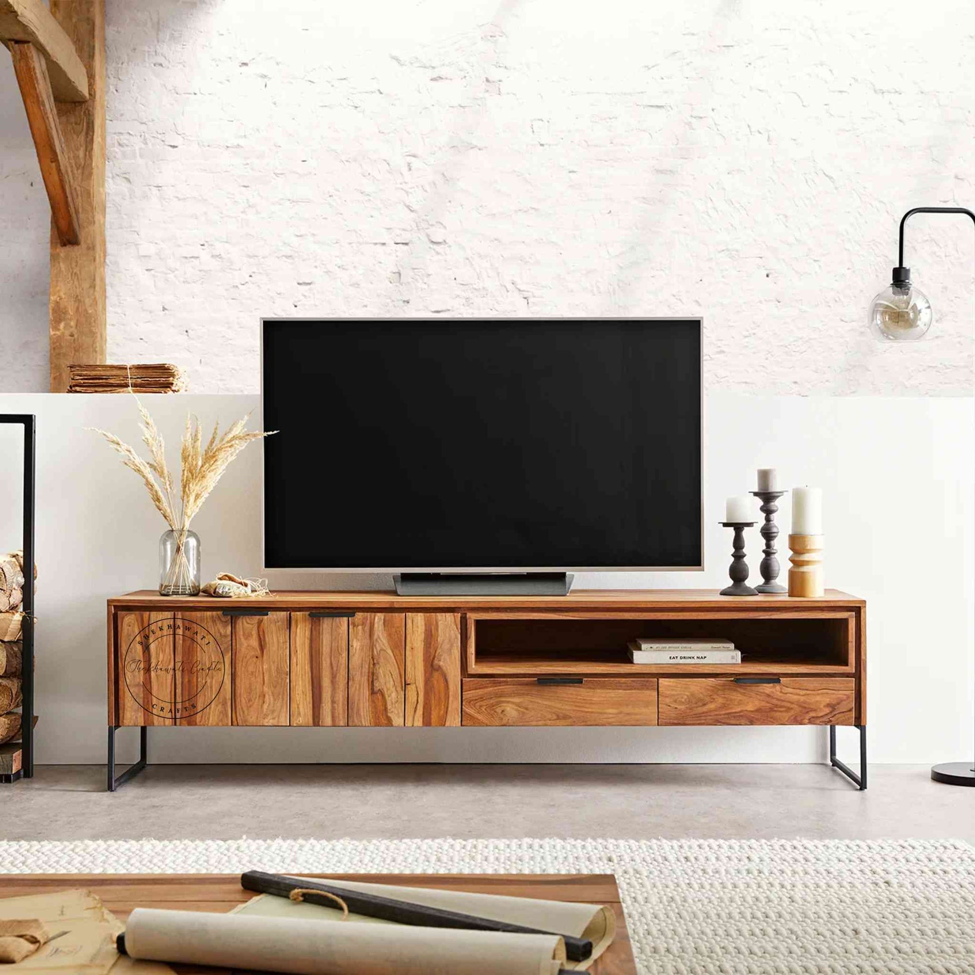 Monroe TV Cabinet is handcrafted with sheesham wood and iron legs. Features a natural finish, 2 drawers, an open shelf and 2 doors.