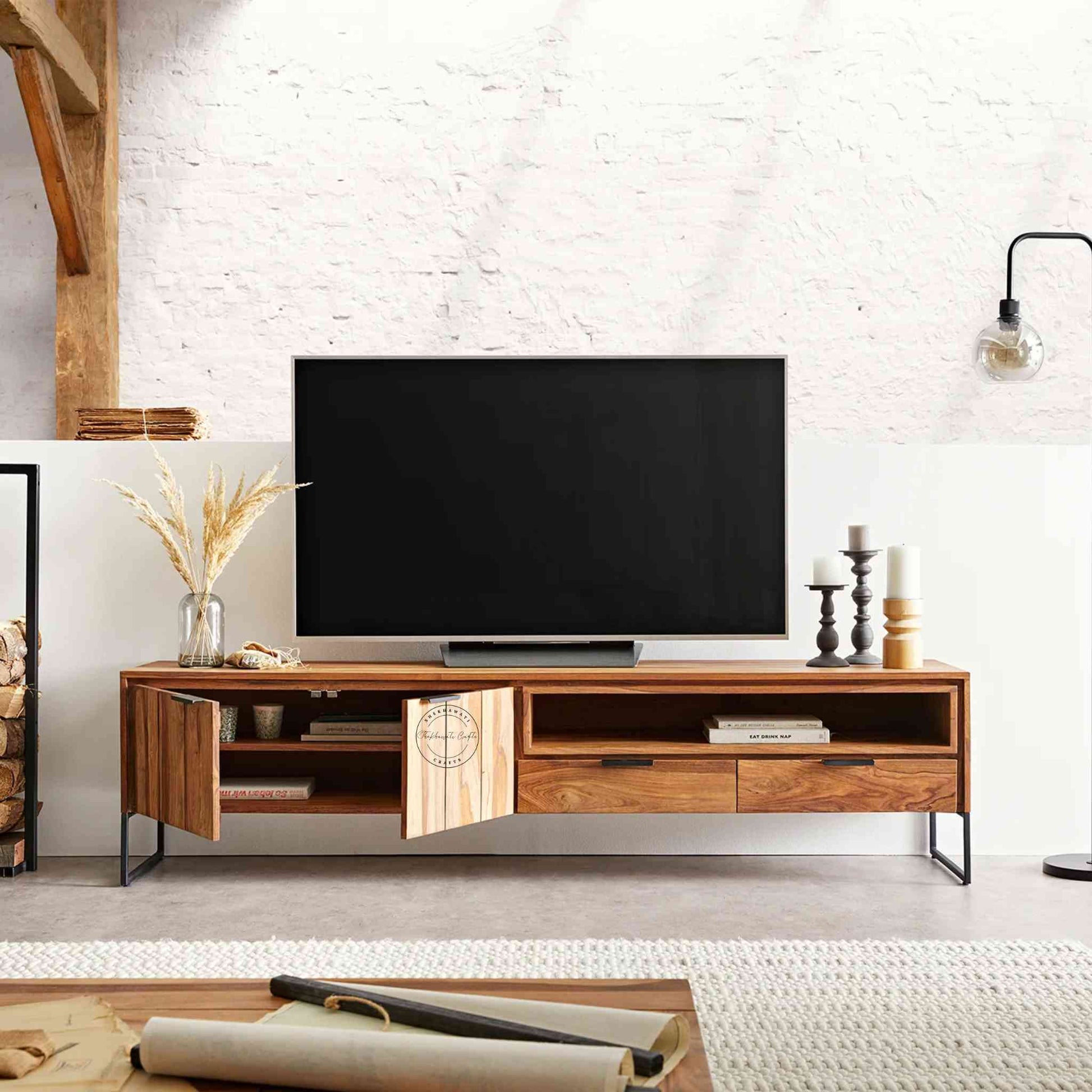 Monroe TV Cabinet is handcrafted with sheesham wood and iron legs. Features a natural finish, 2 drawers, an open shelf and 2 doors.