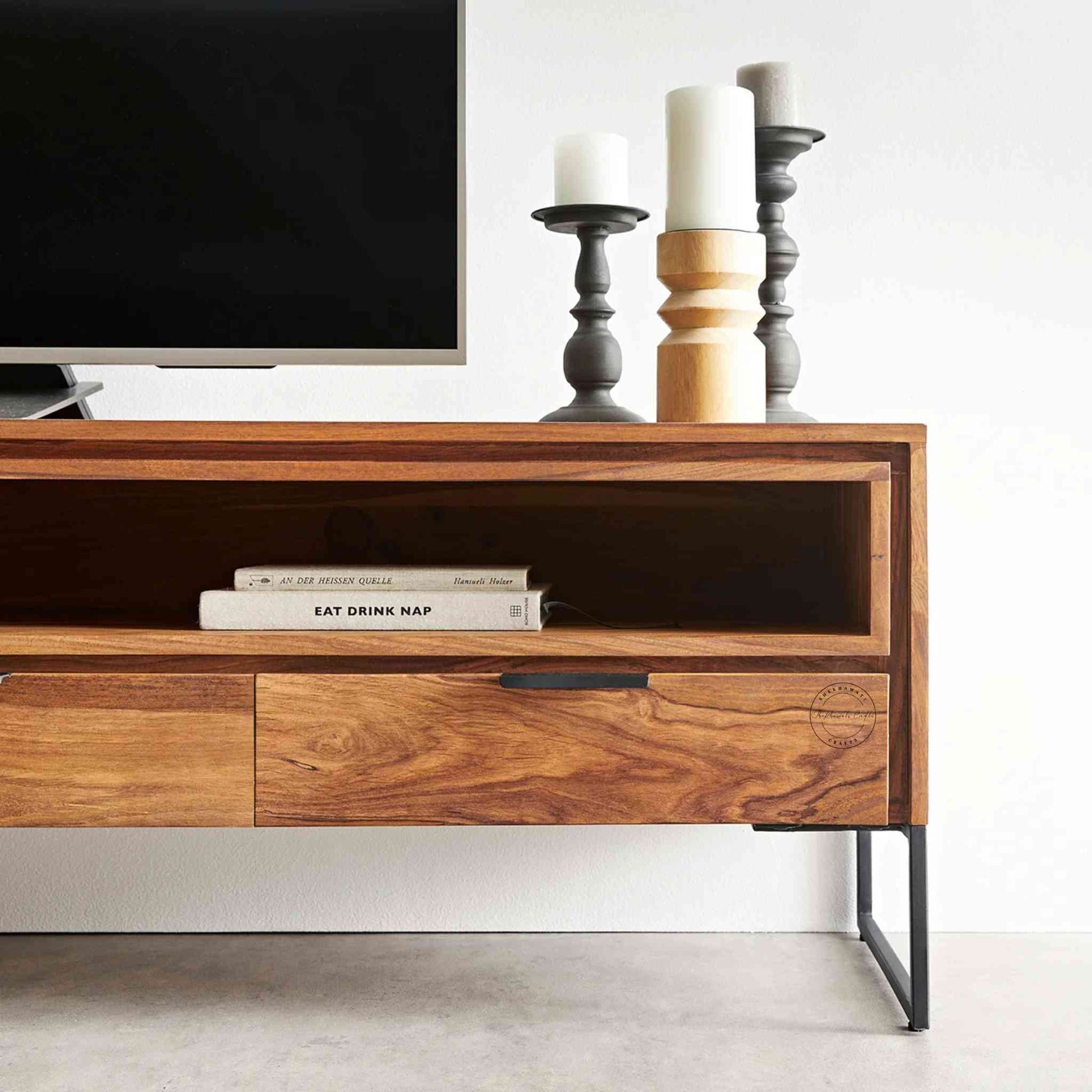 Monroe TV Cabinet is handcrafted with sheesham wood and iron legs. Features a natural finish, 2 drawers, an open shelf and 2 doors.