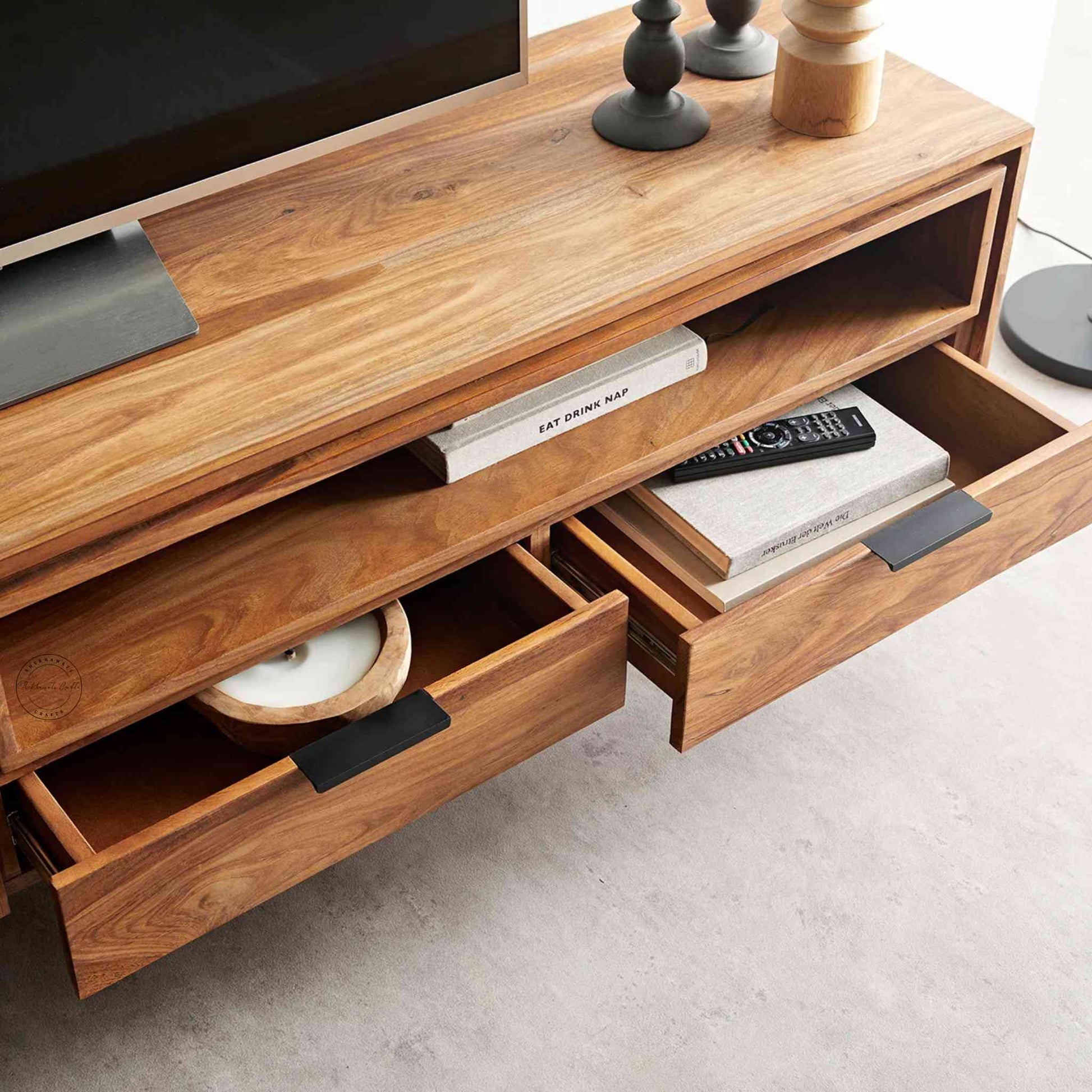 Monroe TV Cabinet is handcrafted with sheesham wood and iron legs. Features a natural finish, 2 drawers, an open shelf and 2 doors.