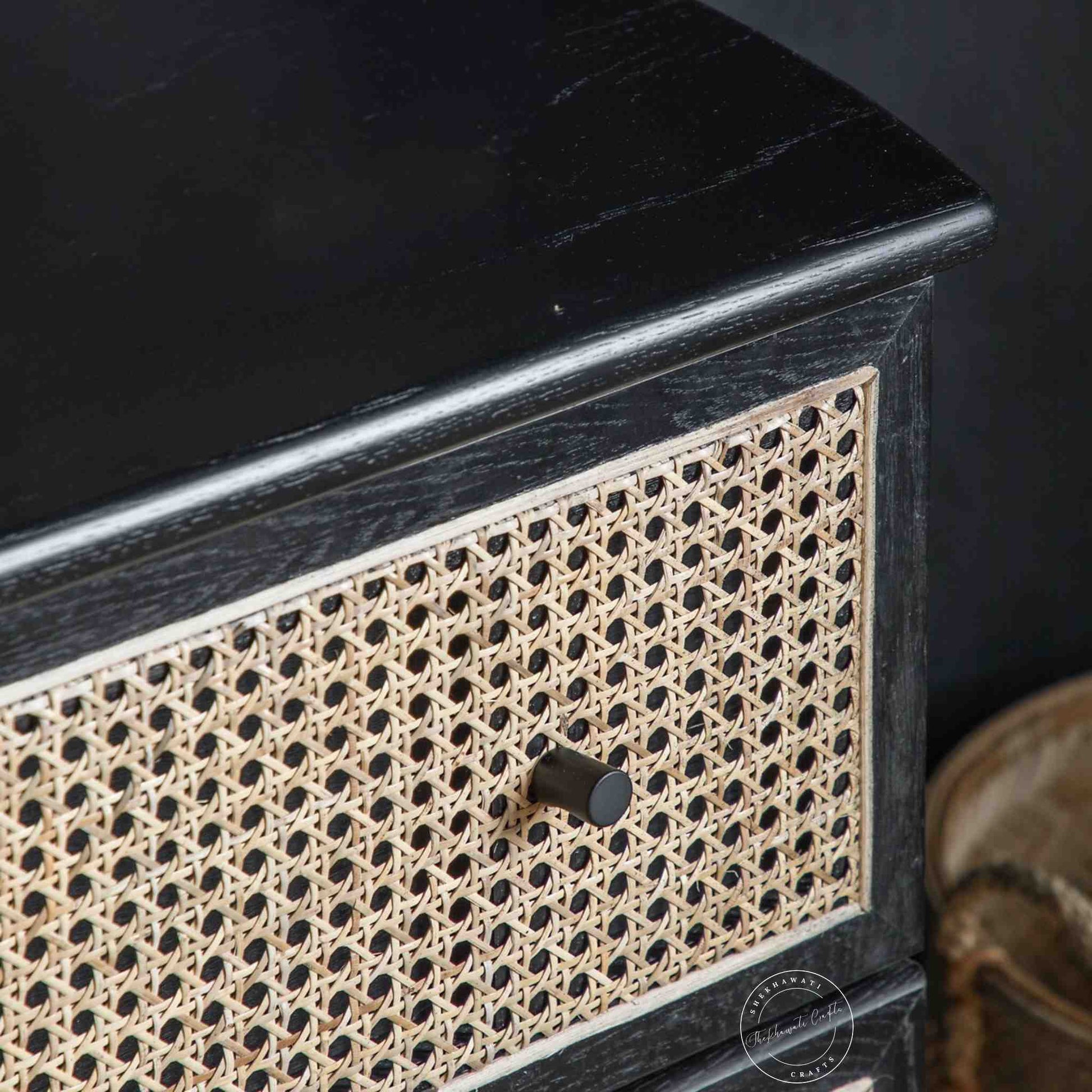 Murphy rattan chest of drawers crafted from solid mango wood with a rattan cane design, featuring a matte black finish and 3 drawers.