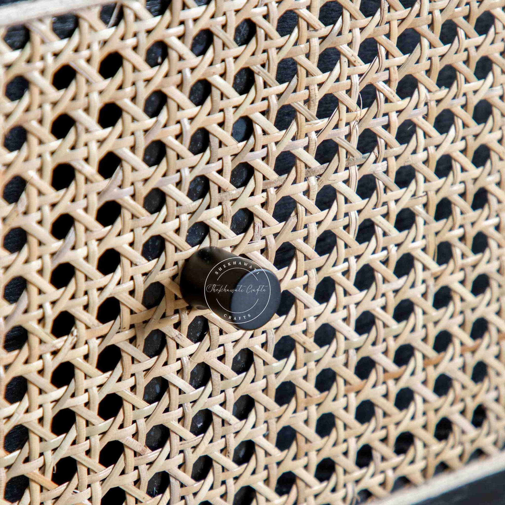 Murphy rattan chest of drawers crafted from solid mango wood with a rattan cane design, featuring a matte black finish and 3 drawers.
