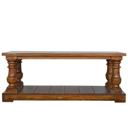 New City Center Table is made from Sheesham wood with a honey finish, antique-inspired design and bottom shelf storage.