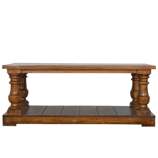 New City Center Table is made from Sheesham wood with a honey finish, antique-inspired design and bottom shelf storage.