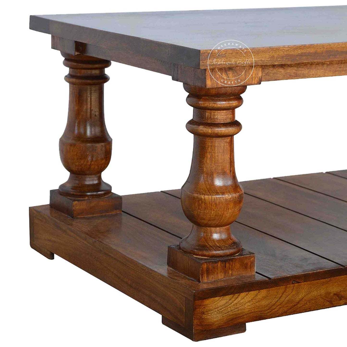 New City Center Table is made from Sheesham wood with a honey finish, antique-inspired design and bottom shelf storage.
