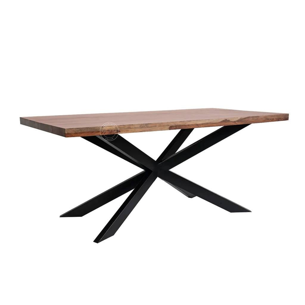 A rectangular dining table with wooden top in a warm brown tone and a black metal X-shaped base, shown on a plain white background.