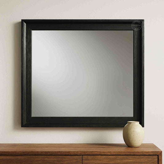 Noir mirror frame is crafted from mango wood with a matte black finish.